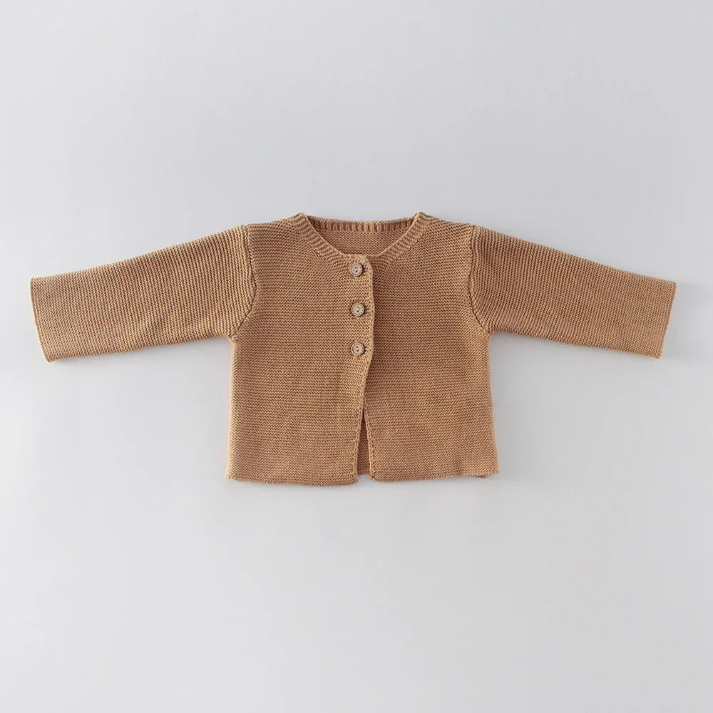 Brown knitted baby cardigan with three buttons on a light gray background