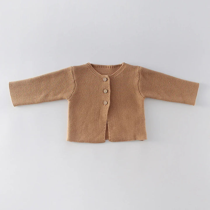 Brown knitted baby cardigan with three buttons on a light gray background