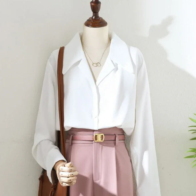 women's white blouse with wide collar tucked into high-waisted pink trousers with gold buckle belt on mannequin
