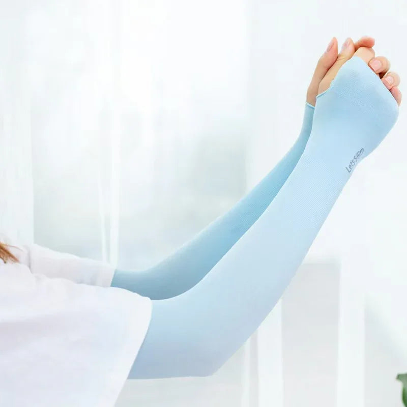 Person wearing light blue arm sleeves with thumb holes and Let’s Slim logo, stretching arms indoors