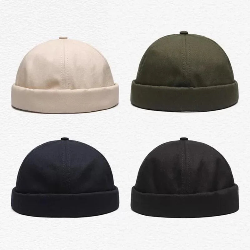Four woolen beanie hats in beige, olive green, navy blue, and black colors on white background