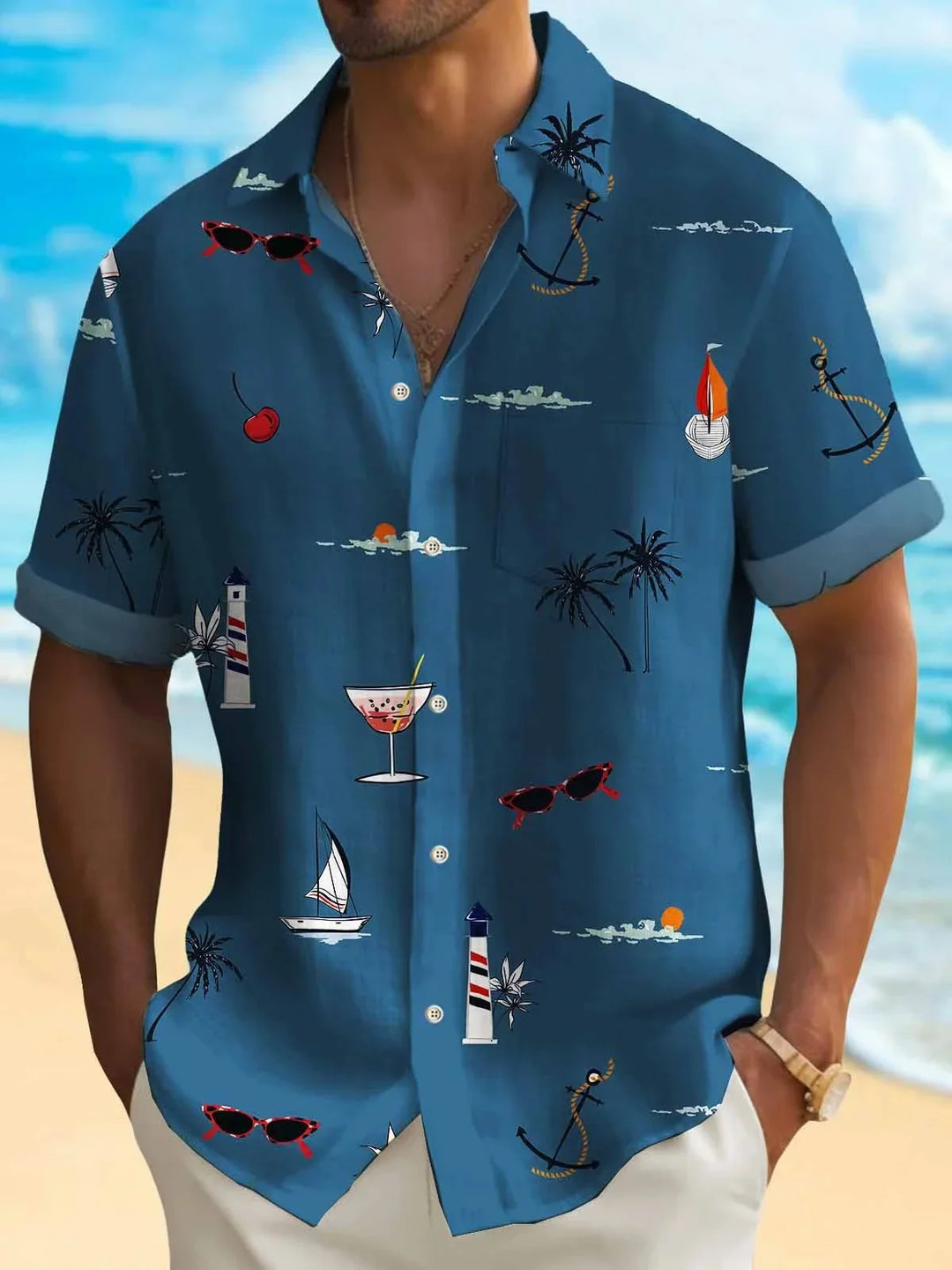 Man wearing blue short-sleeve Hawaiian shirt with nautical and tropical prints at beach