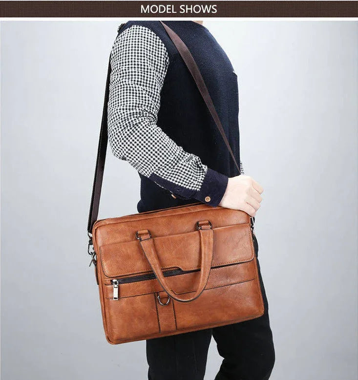 Person carrying brown leather laptop bag with front zipper pocket and handles over shoulder