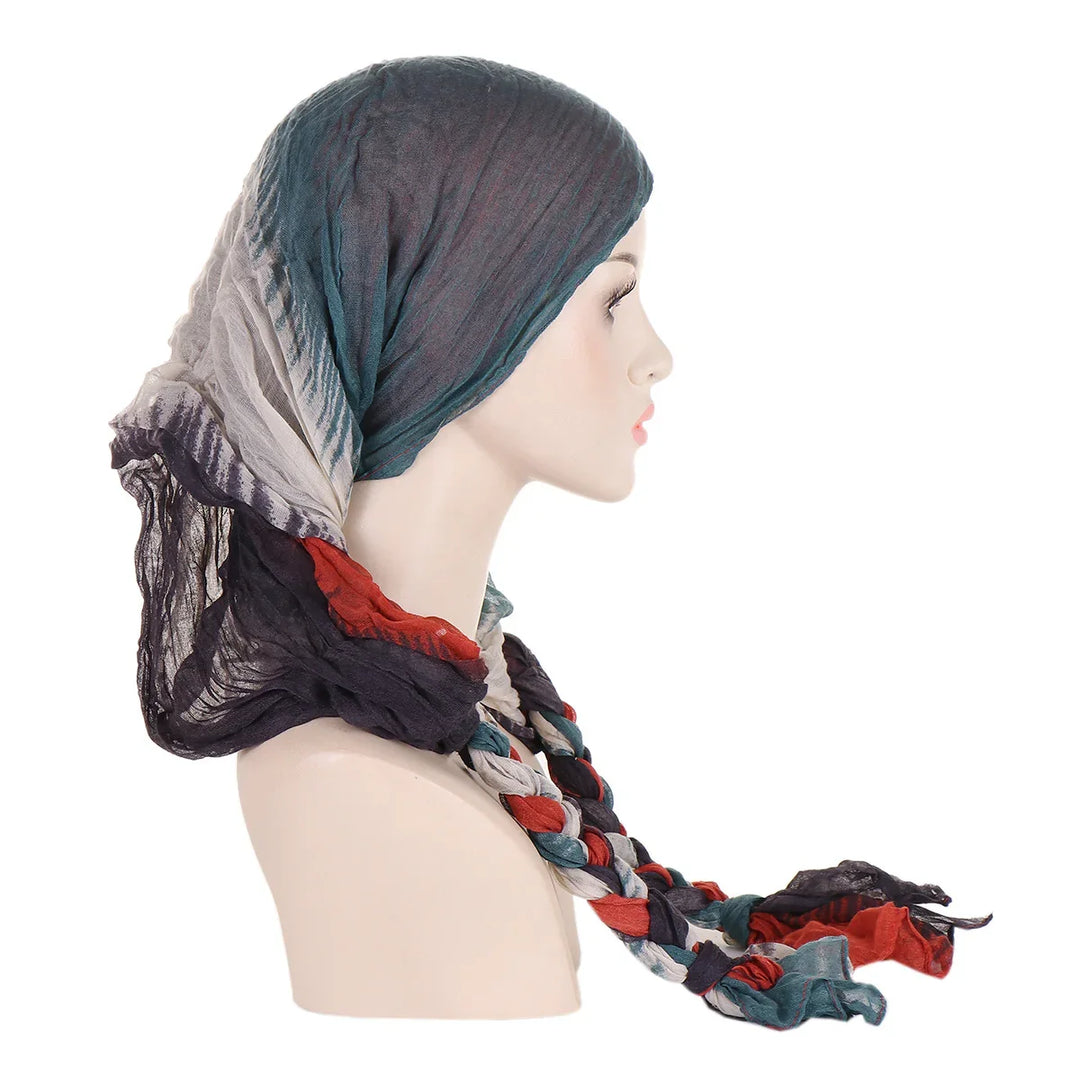 Profile of mannequin wearing multicolored crinkled headscarf and braided scarf accessory