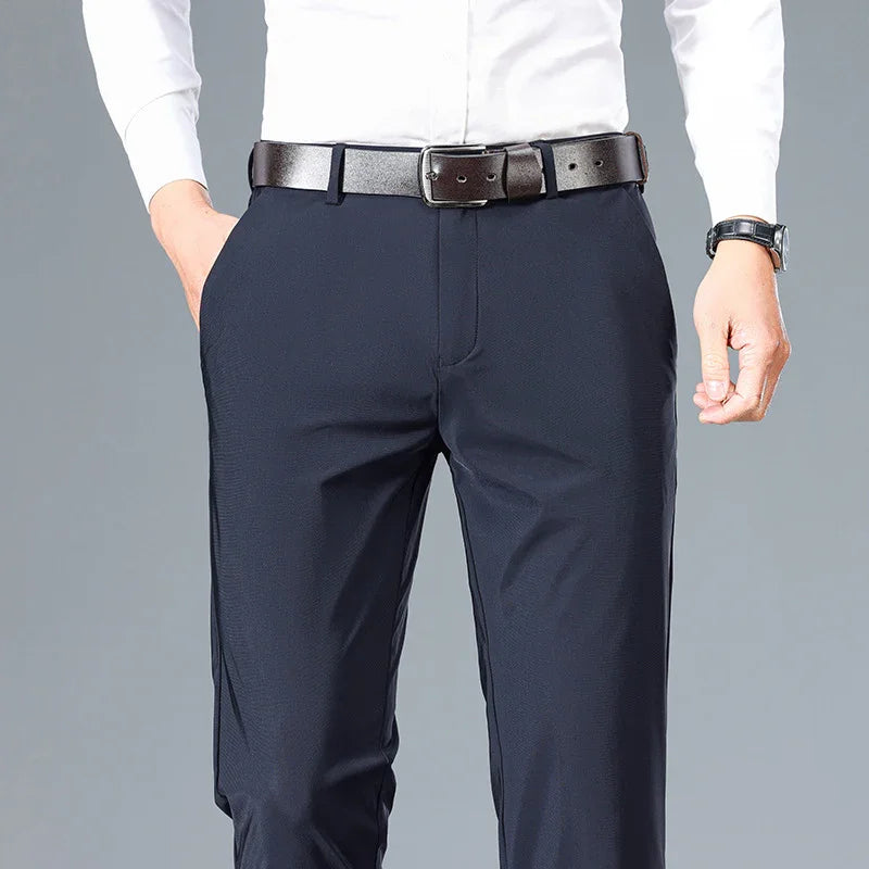 Man wearing navy blue dress pants with black leather belt and white dress shirt