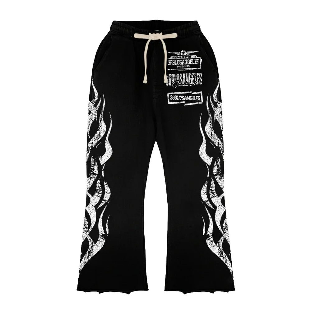 Black sweatpants with white flame graphics on legs and white text print on front with drawstring waistband