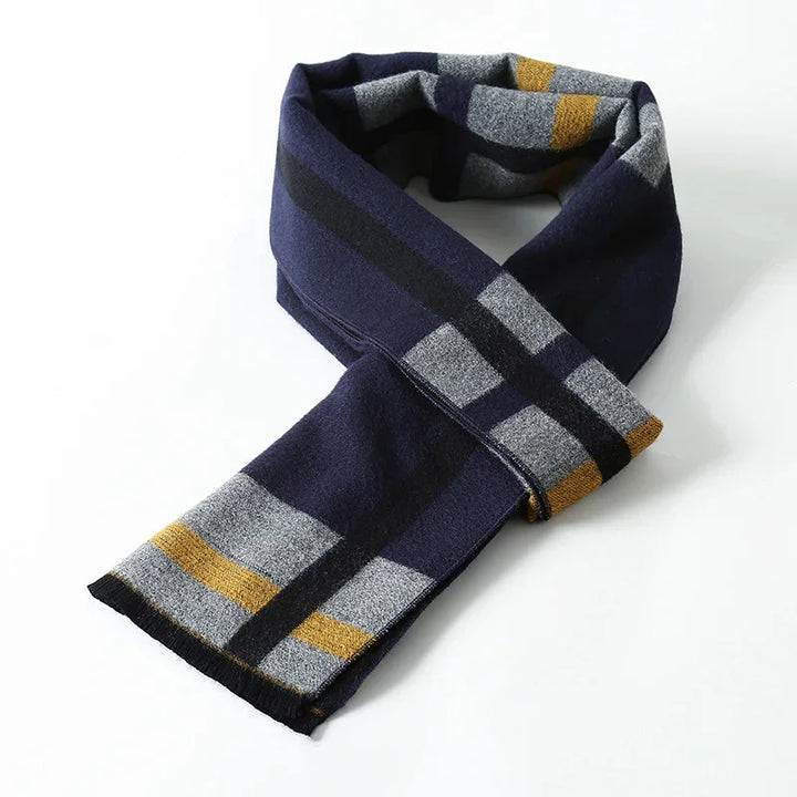 Navy, gray, black, and mustard striped wool scarf folded on white background