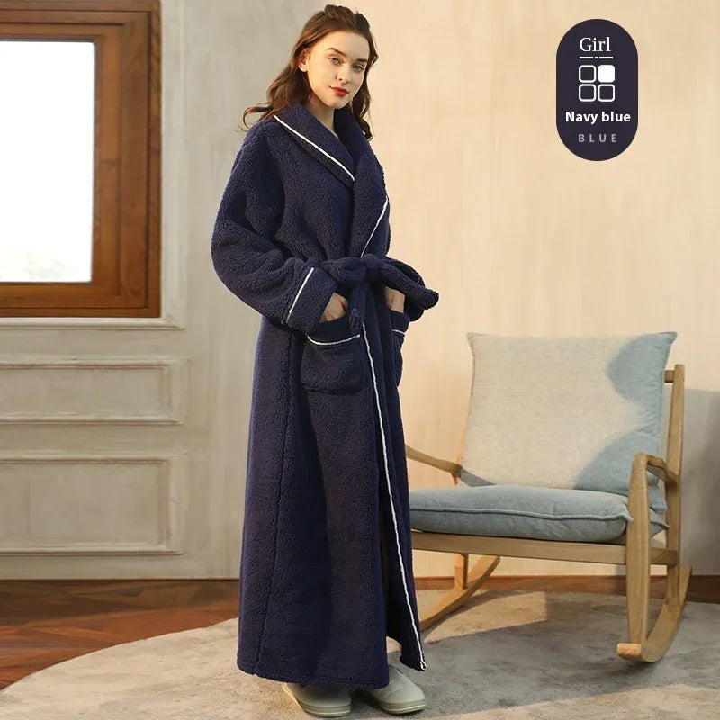 Woman wearing navy blue long plush robe with white trim indoors near rocking chair