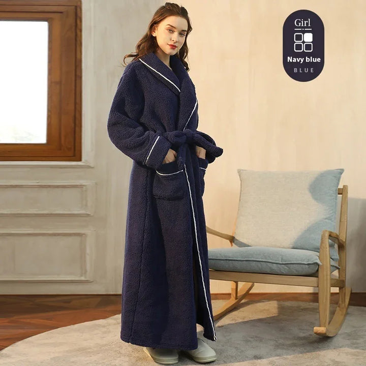 Woman wearing navy blue long plush robe with white trim indoors near rocking chair