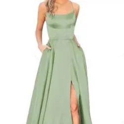 Elegant light green sleeveless dress with front slit and side pockets worn by woman