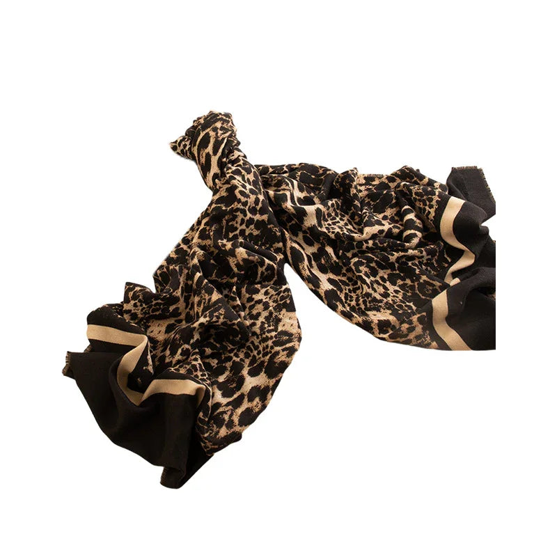 Soft leopard print scarf with black and beige border on white background