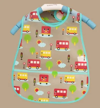 Children's bib with colorful cartoon vehicles, trees, traffic lights, and sun patterns on beige fabric