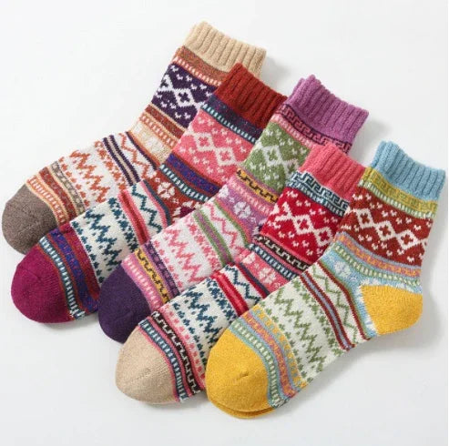 Colorful woolen knit socks with intricate geometric and striped patterns arranged side by side