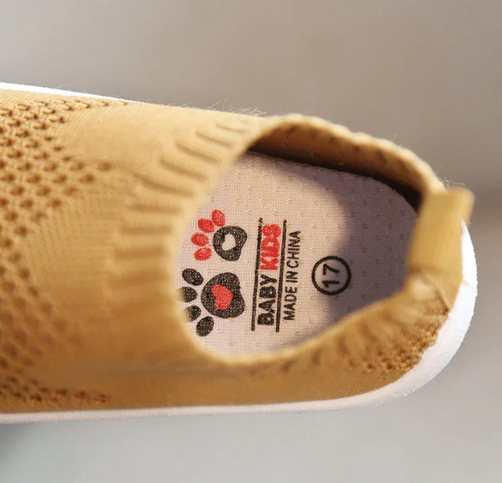 Close-up of a yellow baby shoe with knit texture and insole labeled BABY KIDS made in China size 17