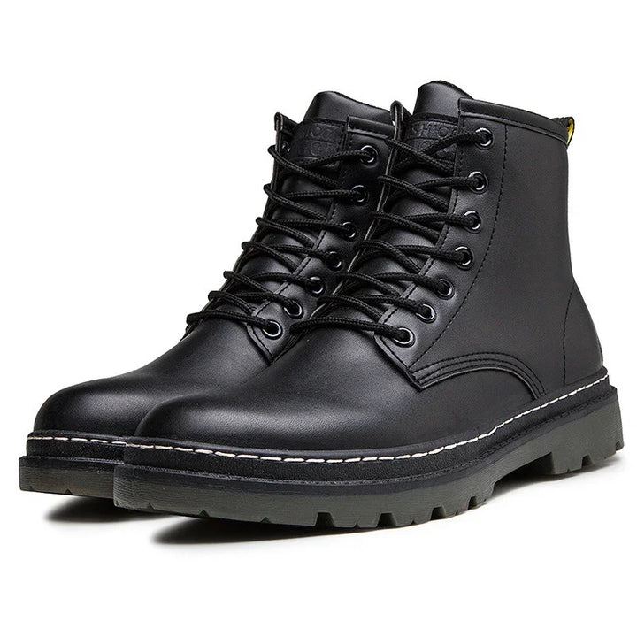 Pair of black leather lace-up boots with rugged sole and white stitching detail