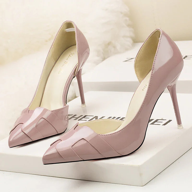 Elegant blush pink patent leather high heel shoes with pointed toes on white box