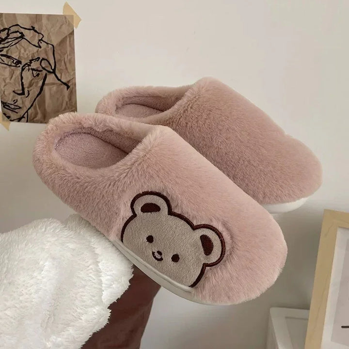 Soft pink plush indoor slippers with cute bear face embroidery on side