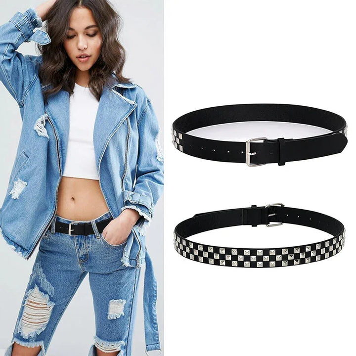 Black studded belt with silver square studs shown on model wearing distressed denim and white crop top