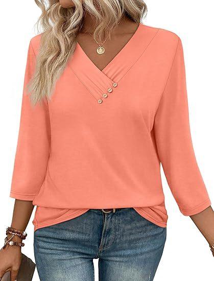 woman wearing coral pink V-neck blouse with button detail and 3/4 sleeves paired with blue jeans