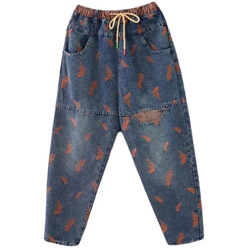 Casual blue denim jogger pants with orange feather print, elastic waistband, and drawstring