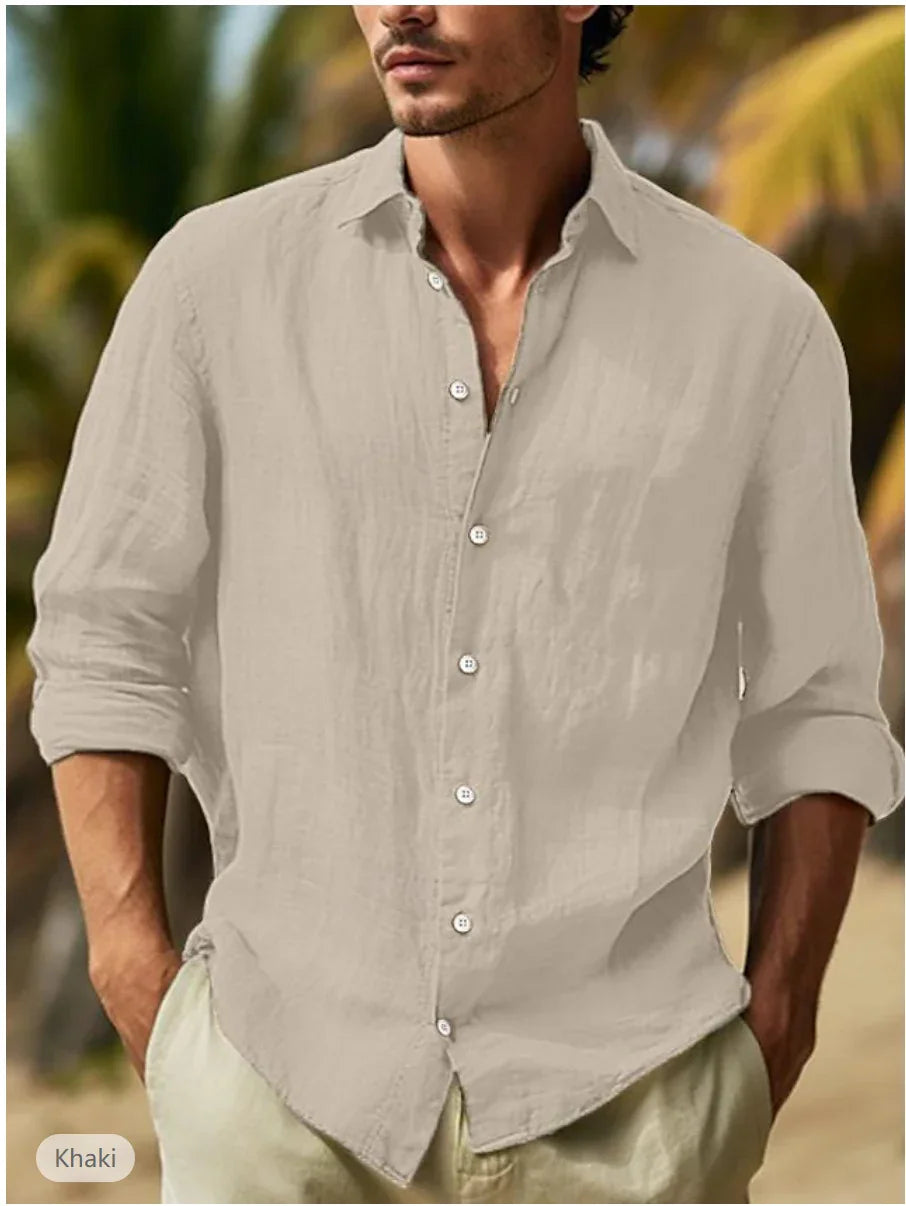 Man wearing khaki button-up linen shirt with rolled sleeves in outdoor tropical setting