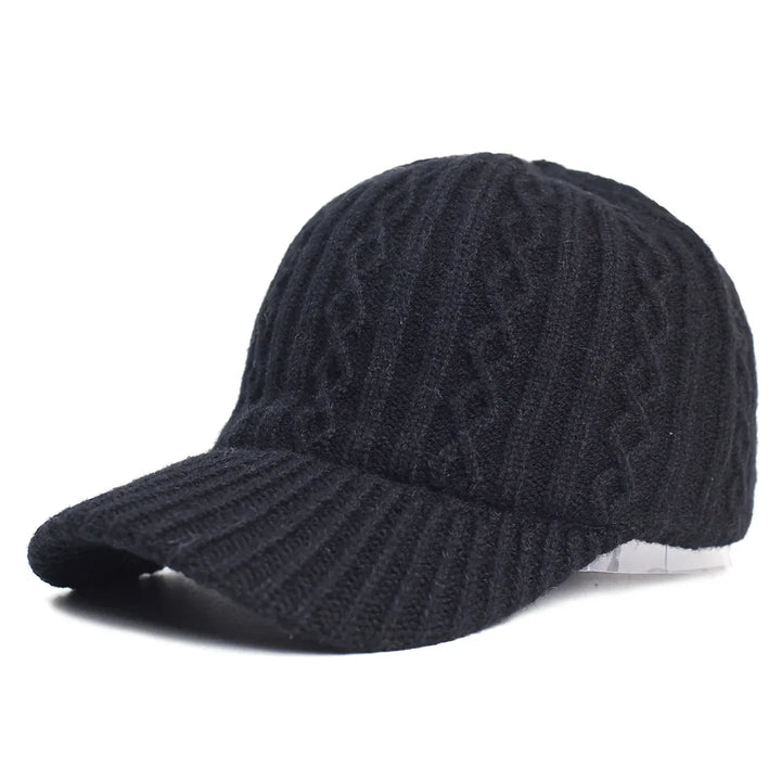 Black knitted wool baseball cap with cable knit pattern on white background