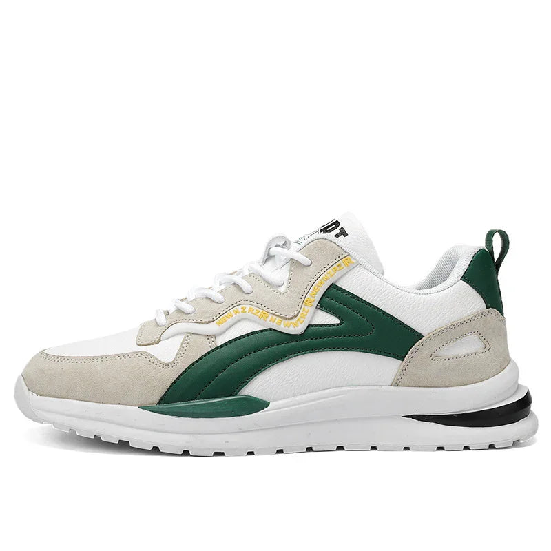 White and beige sneaker with dark green accents, white laces, and a rubber sole