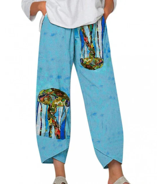 Blue loose pants with colorful abstract jellyfish print and cross-hem detail