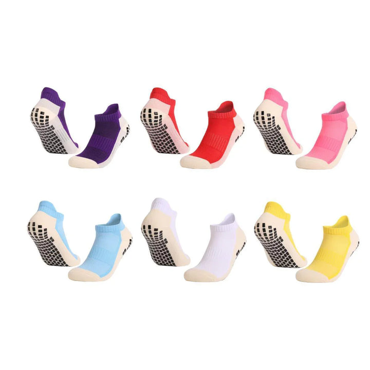 Set of eight colorful non-slip ankle socks with grippy soles in purple, red, pink, blue, white, and yellow