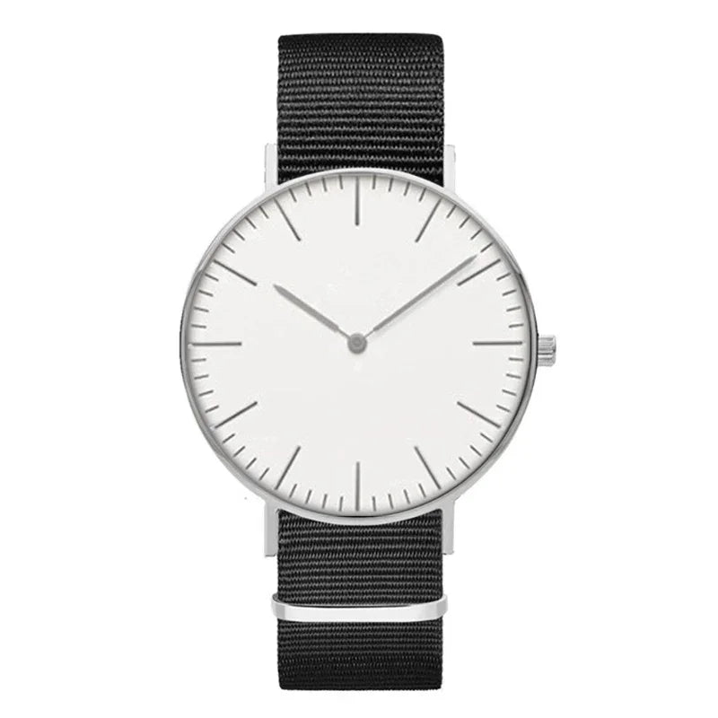 Minimalist wristwatch with black fabric strap and white dial showing 10:10 time