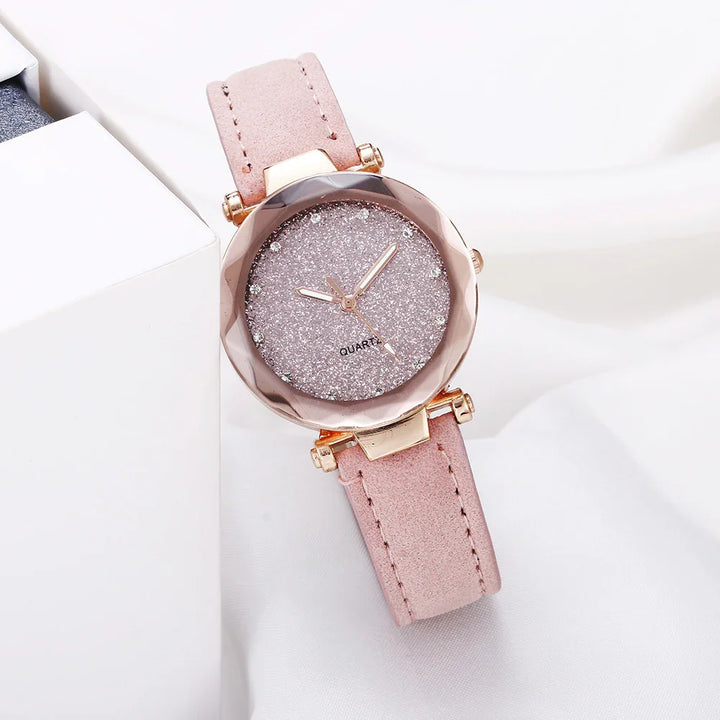 Elegant pink quartz wristwatch with glittery dial, rose gold case, and soft leather strap