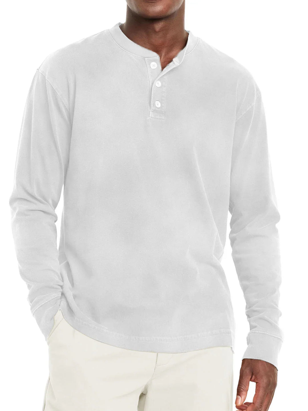 Man wearing white long-sleeve henley shirt with three buttons and beige pants