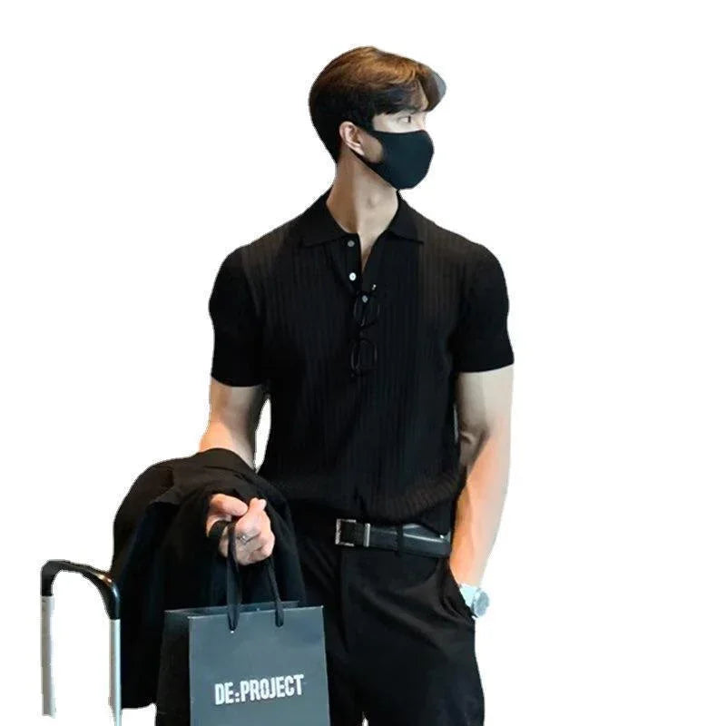 Man wearing black polo shirt and face mask holding DE:PROJECT shopping bag and jacket