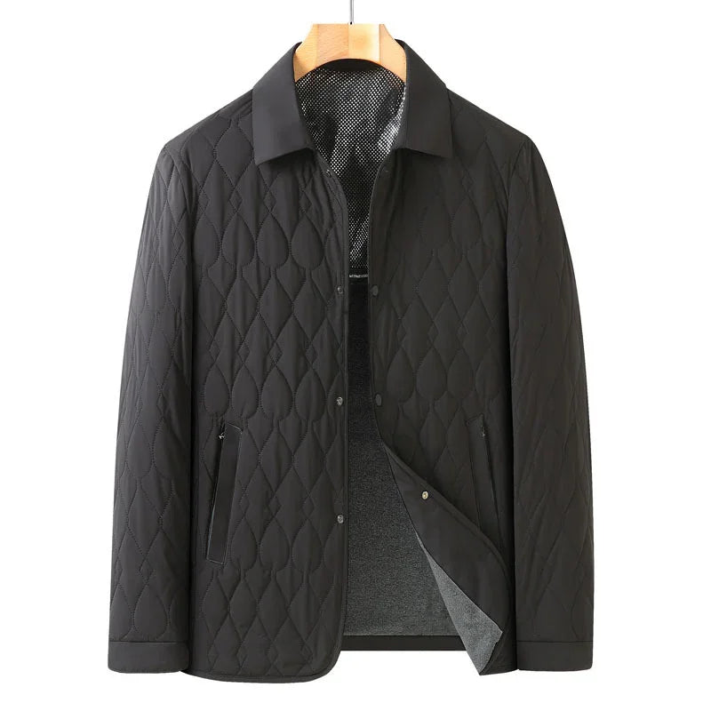 Black quilted men's jacket with snap buttons and zippered pockets on wooden hanger