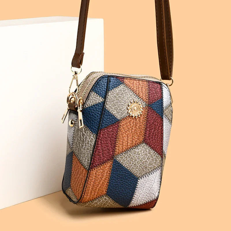 Small multicolor geometric leather crossbody bag with brown strap and gold zipper
