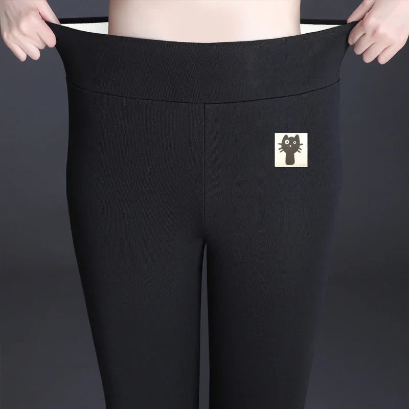 Person stretching waist of black leggings with cute black cat patch on front