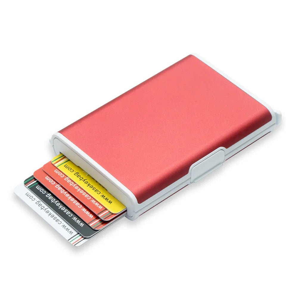 Red aluminum card holder wallet with multiple colorful cards partially pulled out on white background