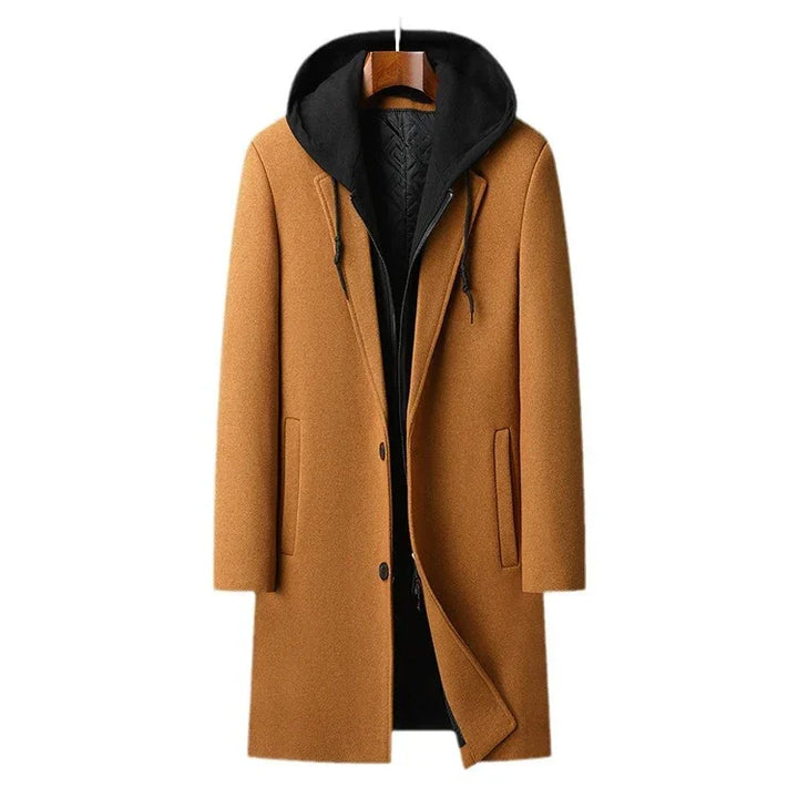 Men's long camel wool coat with black inner hooded zip-up jacket, front pockets, and button closure