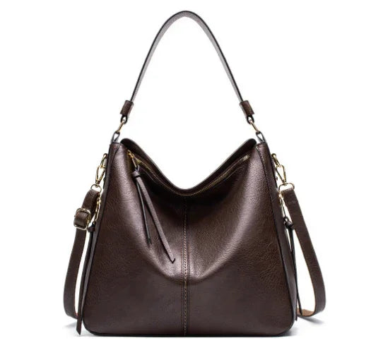 Dark brown leather shoulder bag with dual straps and gold hardware against white background