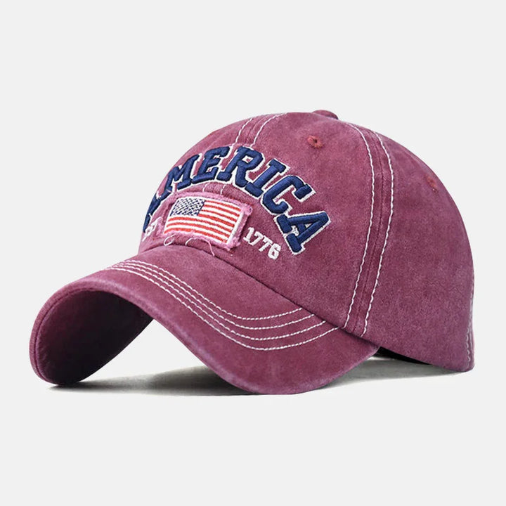 Maroon baseball cap with embroidered US flag and 'MERICA 1776' text, white stitching detail