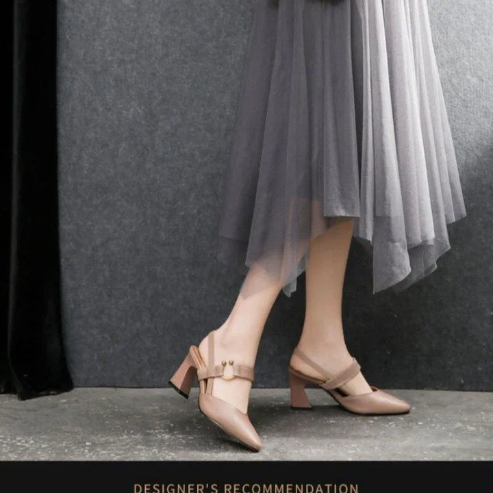 woman wearing beige pointed-toe block heel slingback shoes with buckle over sheer gray skirt