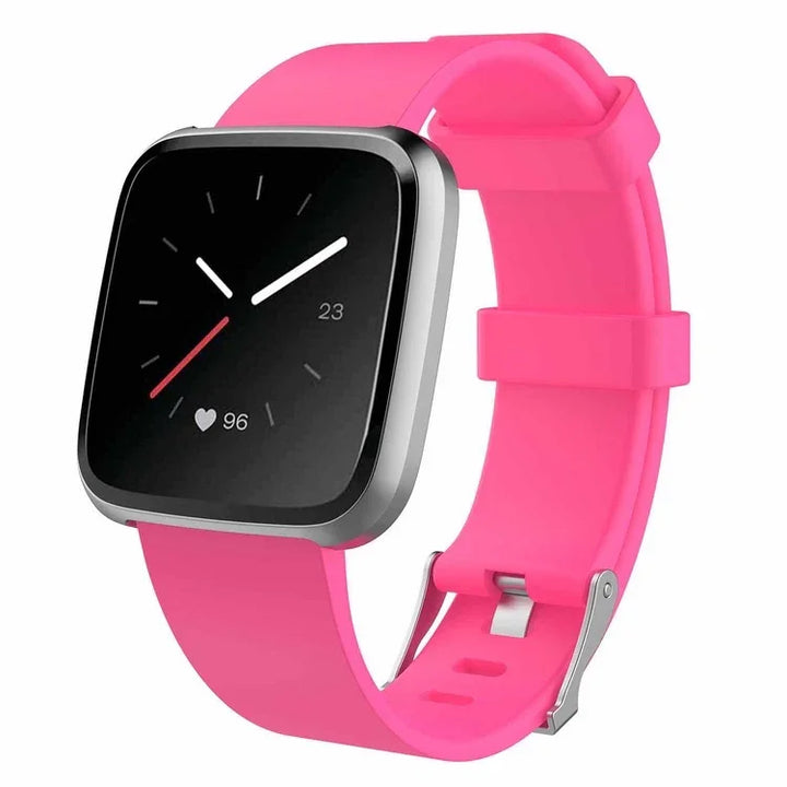 Modern smartwatch with heart rate monitor and pink silicone band displayed on white background