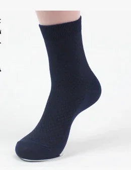 Single navy blue ankle sock on foot against white background