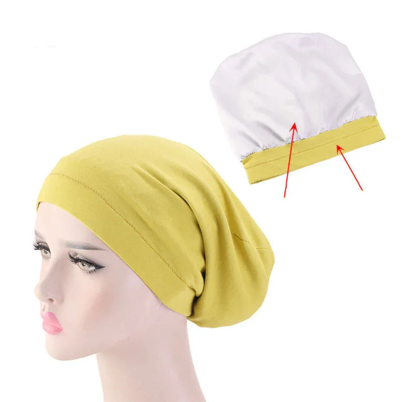 Yellow slouchy beanie hat on mannequin head with inner white cap featuring yellow trim