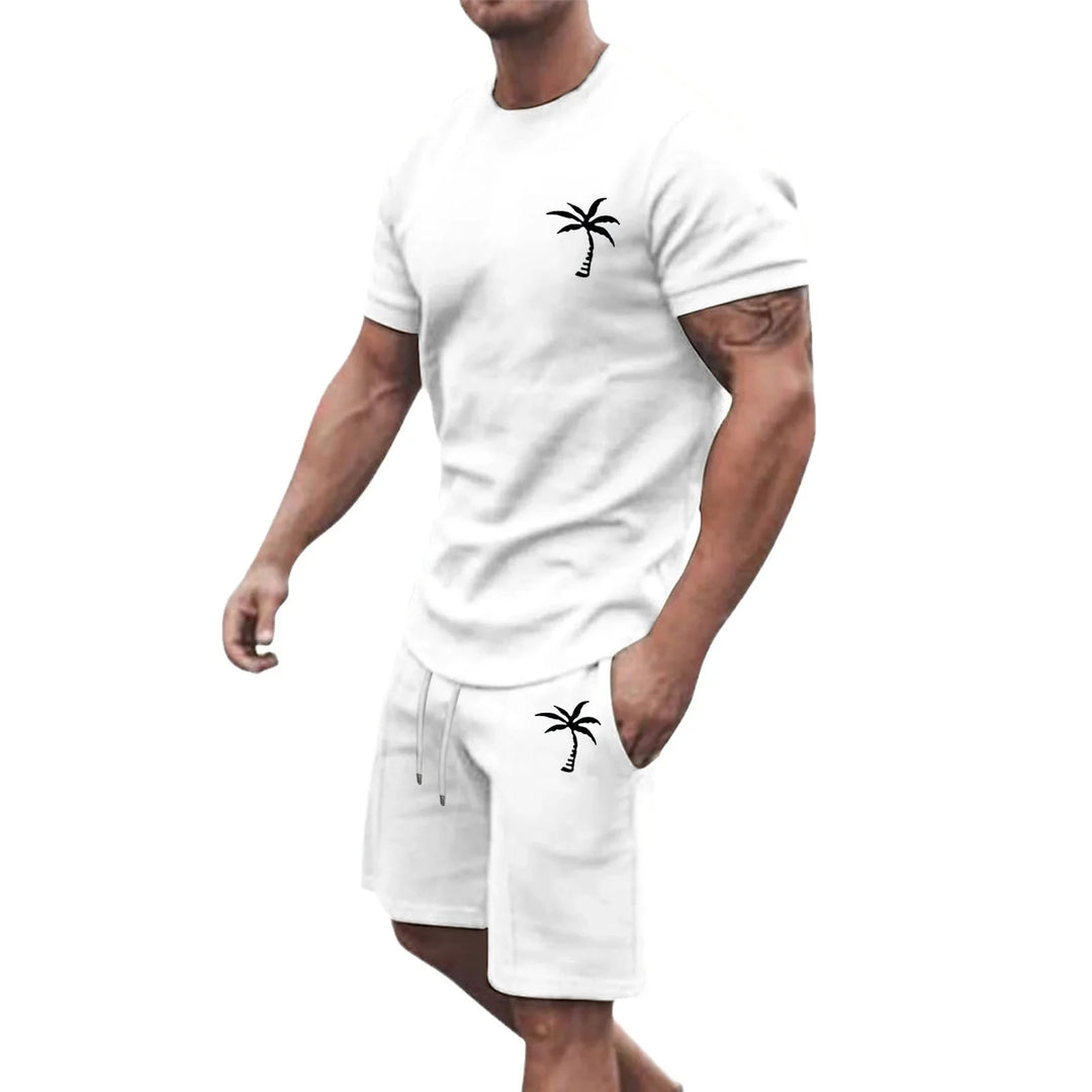 Muscular man wearing a white casual t-shirt and shorts set with black palm tree prints