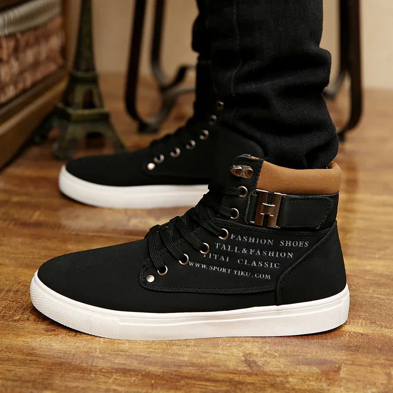 Black high-top fashion shoes with white soles and brown padded collar worn on wooden floor
