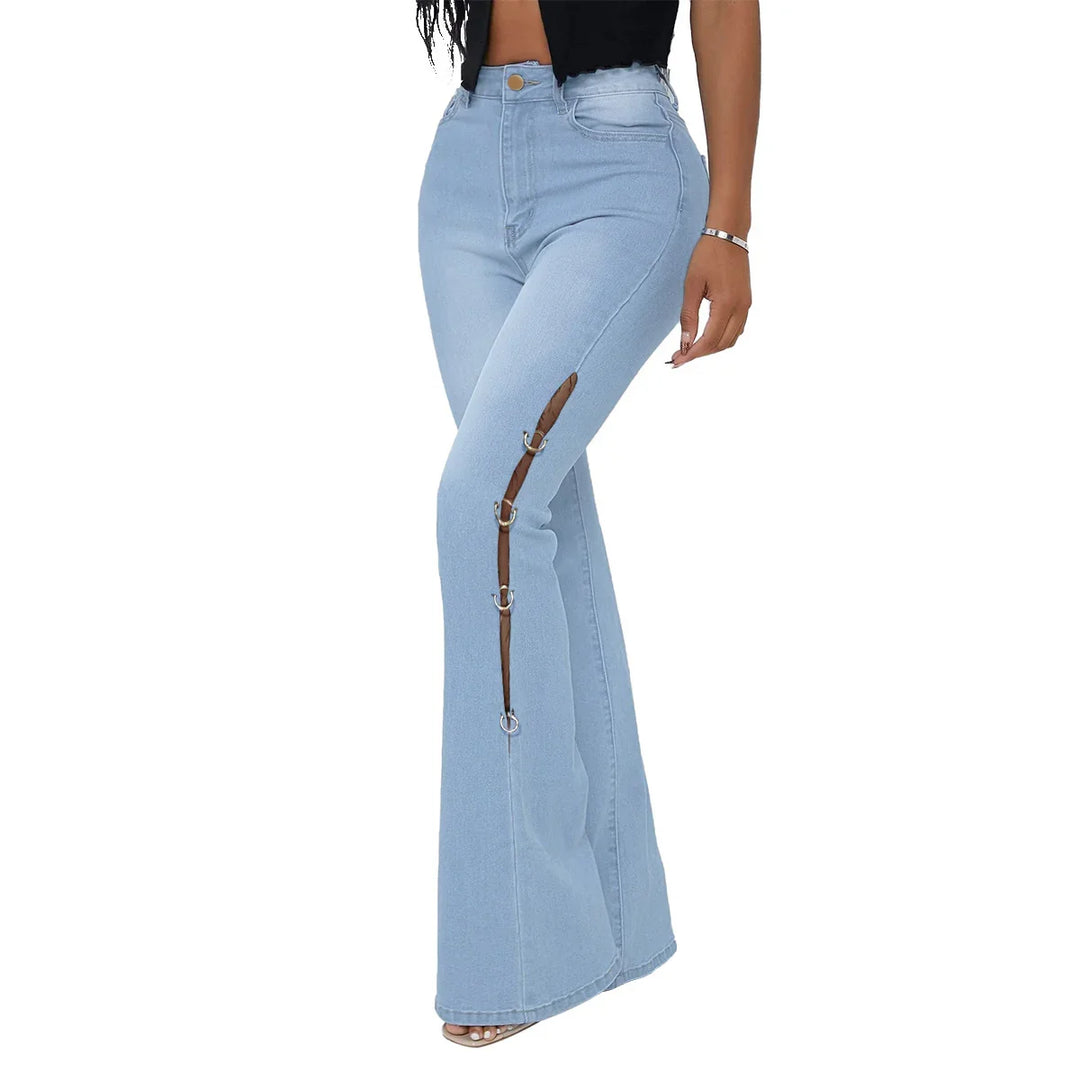 Woman wearing light blue high-waisted flared jeans with front leg mesh cutout and silver rings