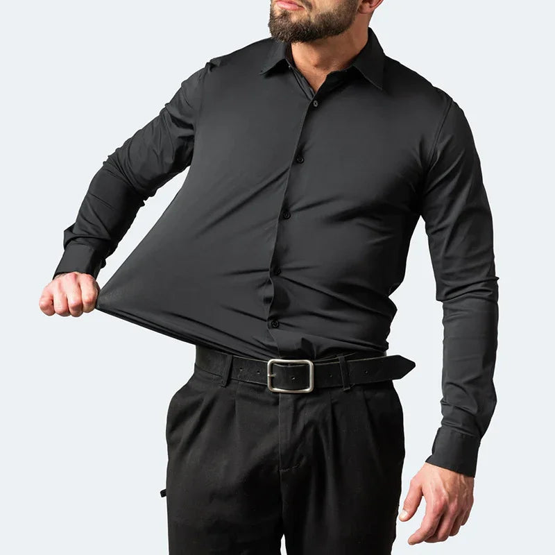 Man wearing a stretch black button-up dress shirt pulling the fabric to show flexibility