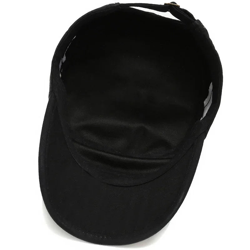 Black cotton adjustable visor cap with curved brim on white background