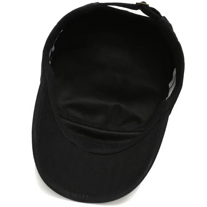 Black cotton adjustable visor cap with curved brim on white background